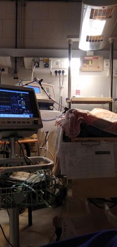 a hospital room with medical equipment on the floor and lights in the ceiling above them