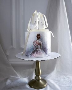 a cake with a painting of a woman in a ball gown on top of it