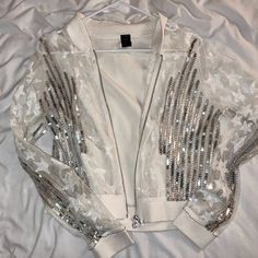 Super Unique - Worn Once! Bought From Ruelala Worn Once, Sporty Jacket. Badgley Mischka For Diesel. Rare Designer Collab! White Mesh Bomber Jacket With Sequin Stars, And Sequin & Beaded Stripes. Sheer Front & Sleeves. Solid, Stretchy Back Panel. Stretch Cuffs & Waistband. Full Zip Front. See Through, Very Light. All Stones Intact. 50% Polyester, 50% Cotton Sporty Silver Long Sleeve Outerwear, Metallic Shiny Fitted Outerwear, Silver Cropped Jacket, Fitted Silver Sequined Outerwear, Sporty Jacket, Luxury Single-breasted Jacquard Outerwear, White Mesh, Badgley Mischka, Bomber Jacket