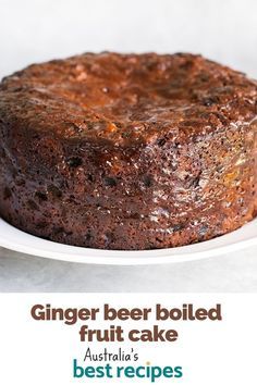 a close up of a cake on a plate with the words ginger beer boiled fruit cake