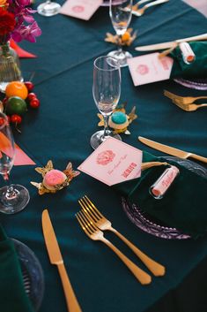 the table is set with place cards and silverware