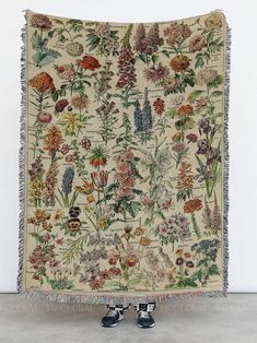 a tapestry with flowers and birds on it