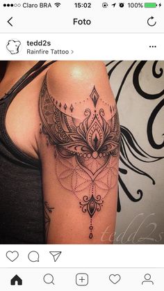 a woman's arm with a tattoo on it that has an intricate design and a feather