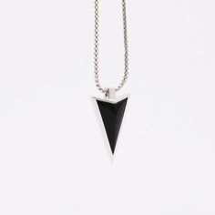 Super cool designer arrow pendant made from sterling silver and black onyx. Be the envy of your friends, with this superb quality master craftsman made piece. There are only a small number available. Buy now to save disappointment. Pendant: Sterling silver & black onyx. Pendant size: 23mm x 13mm / 0.9" x 0.5". Chain: Sterling silver. Chain lengths: 50cm, 60cm, 70cm / 20", 24", 28". Necklace length chart Modern Black Necklace With Large Pendant, Black Minimalist Necklace With Large Pendant, Minimalist Black Necklace With Large Pendant, Sterling Silver Necklace With Large Black Pendant, Black Sterling Silver Necklace With Large Pendant, Modern Silver Necklace With Black Enamel, Modern Black Enamel Necklaces, Modern Black Necklace With Polished Finish, Modern Onyx Necklaces With Polished Finish