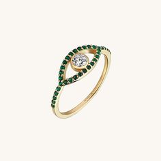 The Green Evil Eye Ring is designed with the evil eye, embellished with green glittering stones that features the protective talisman, defeats the evil looks, and will give you a good luck. You are safe! With its mystic style, it is a great choice to pair with other stackable rings. - Made in 14k solid gold - Decorated with handset green and white cubic zirconia stones on 14k solid gold - Band Width: 1.37 mm / 0.05 inches - Thickness: 1.37 mm / 0.05 inches- Top Width: 13.10x6.49 mm / 0.51 inches Green Spiritual Jewelry With Evil Eye, Spiritual Green Jewelry With Evil Eye, Symbolic Green Gemstone Jewelry, Green Jeweled Round Ring, Mystical Green Rings Perfect For Gifts, Mystic Style, Green Evil Eye, Protective Talisman, Luxury Jewelry Brands