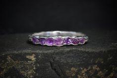 "Wrapped Raw Amethyst Wedding Band Ring // Raw Amethyst Ring // Raw Stone Ring // Raw Amethyst Wedding Band Ring // Amethyst Engagement Ring This listing is for one raw natural stone ring. Pictured ring is in sterling silver. DETAILS:  Stone: natural raw Amethyst Metal:  - 925 silver  - 14k yellow, rose and white gold (stones appear darker in gold) - 18k yellow gold (stones appear darker in gold) Band Width: approx. 2x1mm, hammered Stone part size: approx.2mm high and around 2.7-3mm wide Note: w Purple Crystal Ring With Stone Setting For Wedding, Purple Faceted Jewelry For Wedding, Purple Faceted Wedding Rings, Amethyst Stackable Wedding Rings, Purple Amethyst Stackable Ring For Wedding, Purple Stackable Amethyst Ring For Weddings, Wedding Amethyst Stackable Rings, Crystal Wedding Band, Rustic Engagement Rings