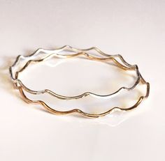 This listing is for 1 bangle Wavy mermaid bangles is make with 14 ga gold filled, Sterling silver and 14k Rose gold filled wire. Bangles are hand- formed, hammered and polished for a stunning texture and shine. It looks great worn alone or stack with other shell and charm bangles to create a chic, fun beachy look. Each bangle is custom made to order so can not be return or exchange for that reason. I can custom made your bangle with any charm or gemstone for birthstone please contact me for cust Adjustable Wavy Stackable Jewelry, Adjustable Stackable Wavy Jewelry, Charm Bangles, Wire Bangles, Jewelry Safe, Mermaid Scales, Solid Gold Jewelry, Charm Bangle, Flower Charm