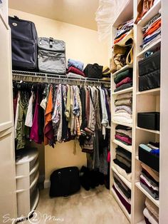 an organized closet with clothes and suitcases