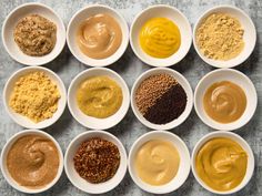 nine bowls filled with different types of food in them on a counter top next to each other