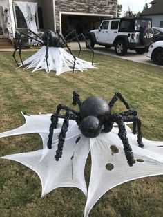 some black and white spider sculptures in the grass