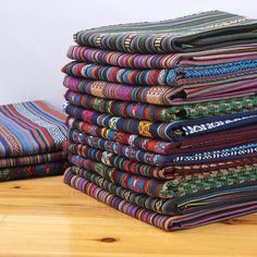 a stack of cloths sitting on top of a wooden table