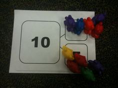 the number ten is placed on top of an envelope with colorful gummy bears around it