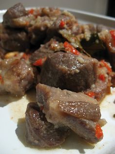 some meat and vegetables on a white plate