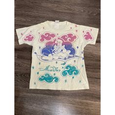 a t - shirt with an image of the little mermaid on it