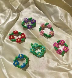 four different colored beads on a white cloth