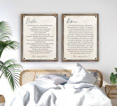 two wooden framed posters above a bed in a room with white linens and pillows