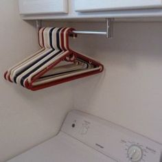 a washer and dryer sitting next to each other in a room with white cabinets