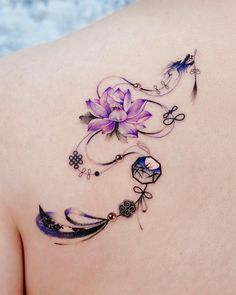 a woman's back with tattoos and flowers on it