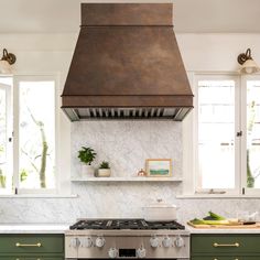 a stove top oven sitting inside of a kitchen next to green cabinets and counter tops