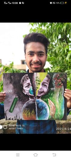 a man holding up a poster with two faces on it and trees in the background