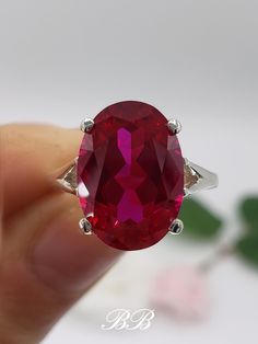 Made to order. Please allow up to 3 weeks for the production of your ring. This listing is for a 925 unplated sterling silver solitaire ring with a lab created ruby oval cut gemstone. Gemstone Type: Lab Created Ruby Shape: Oval Cut Size: 14x10mm Weight: 6 Carat Approximately Color: Ruby Quality: AAA Hardness: 9 Mohs Metal Options (all solid non-plated metals) 925 Sterling Silver 10KT White Gold 10KT Yellow Gold 14KT White Gold 14KT Yellow Gold 14KT Rose Gold Did you know lab-created rubies are equivalent to natural rubies? Lab grown rubies have the same chemical composition as natural rubies. They have the same refractive index (sparkle), specific gravity etc. They are made of corundum, the same thing mother nature makes natural rubies from but at a fraction of the cost!  Watch the video t Red Oval Ring With Polished Finish, Red Ruby Ring With Oval Accent Stones, Hallmarked Oval Red Ruby Ring, Red Ruby Ring With Oval Shape And Accent Stones, Red Ruby Ring With Oval Cut And Accent Stones, Red Oval Jewelry With Prong Setting, Oval Ruby Ring With Red Accent Stones, Hallmarked Oval Ruby Ring In Red, Oval Ruby Ring With Vs Clarity