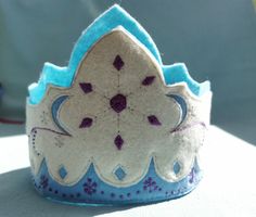 a blue and white crown sitting on top of a table