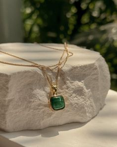 Product Description Striking and sophisticated, our Malachite pendant necklace showcases the rich, vibrant patterns of this powerful stone. Malachite is known for its healing properties, believed to bring balance and protection to the wearer. …………………………………. D E T A I L S Pendant measures 21 mm x 12 mm Chain style: curb Clasp type: spring Tarnish-resistant, waterproof, safe for sensitive skin Lead-free and nickel-free Material: 18k Gold Fill and natural Malachite Elegant Emerald Necklace With Large Pendant, Elegant Turquoise Necklace With Detachable Pendant, Elegant Jewelry With Square Pendant Natural Stones, Elegant Square Pendant Necklace With Natural Stones, Elegant Square Pendant Jewelry With Natural Stones, Elegant Turquoise Jewelry, Tarnish Resistant, Green Pendant Jewelry With Clavicle Chain, Elegant Malachite Necklace With Natural Stones, May Birthstone Amulet Pendant Necklace