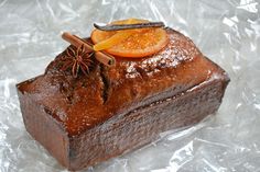 a piece of chocolate cake with an orange slice on top and cinnamon sticks sticking out of it