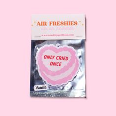 an air freshener with the words only fried once on it in pink and white