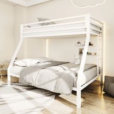 a white bunk bed sitting on top of a hard wood floor