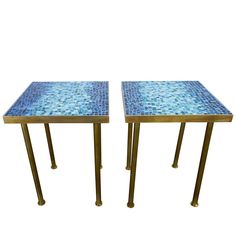 a pair of tables with blue mosaic tiles on them