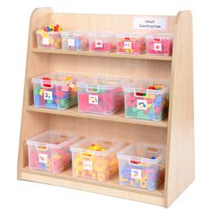 a wooden shelf filled with plastic bins and toys