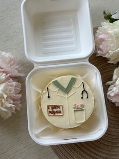 a cake in a box with flowers around it