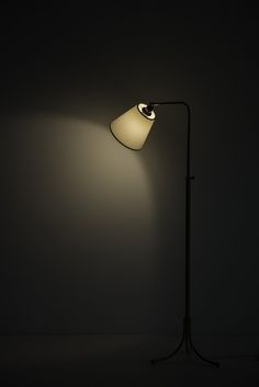 a lamp that is lit up in the dark with a white light on it's side