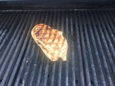 a piece of meat is cooking on the grill