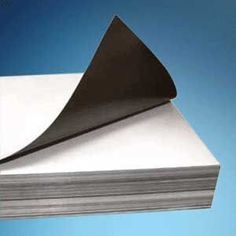 a stack of white paper sitting on top of a blue background with a black piece of paper sticking out of it