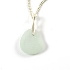 a white sea glass necklace on a chain