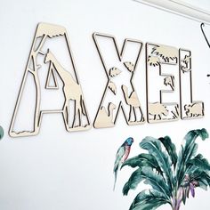 the letters are made out of wood and have animals on them, including a bird