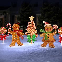 lighted gingerbreads and christmas trees in the snow