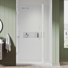 a bathroom with green walls and white fixtures