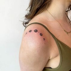 a woman with a tattoo on her shoulder