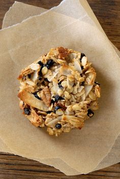 an oatmeal cookie with raisins and blueberries sits on parchment paper