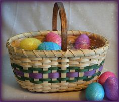 a basket filled with lots of colorful easter eggs