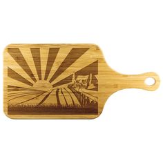 a wooden cutting board with an image of a sunset