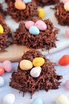 chocolate bird's nest treats on a white plate with candy eggs and mini eggs