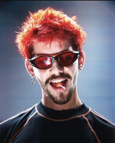 a man with red hair and sunglasses making a funny face