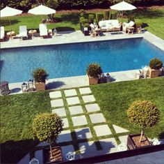 an aerial view of a swimming pool and lawn