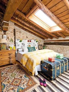 a bedroom with two suitcases on the floor and a bed in the corner next to it