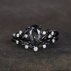 a black diamond ring with white diamonds on it