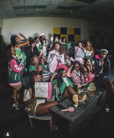 a group of women in green and pink outfits posing for a photo at a party